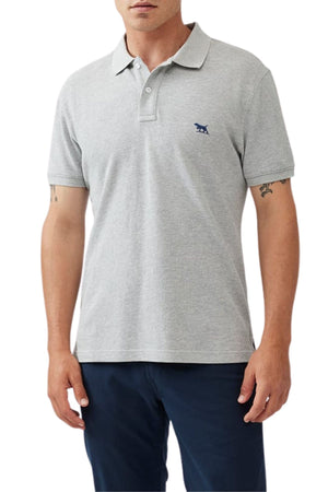 A man wearing the Rodd & Gunn The Gunn Polo in light gray Australian cotton with a small navy animal logo on the chest and paired with dark navy pants, shown from the waist up.