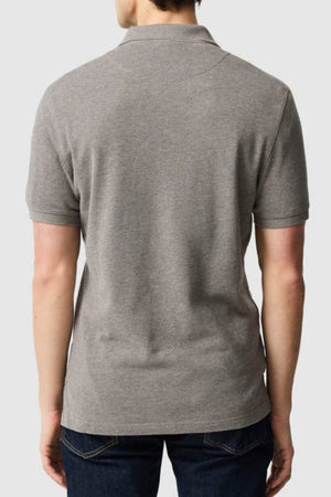 A person wearing a modern fit, short-sleeve gray Rodd & Gunn The Gunn Polo and dark jeans is shown from the back against a plain light gray background.