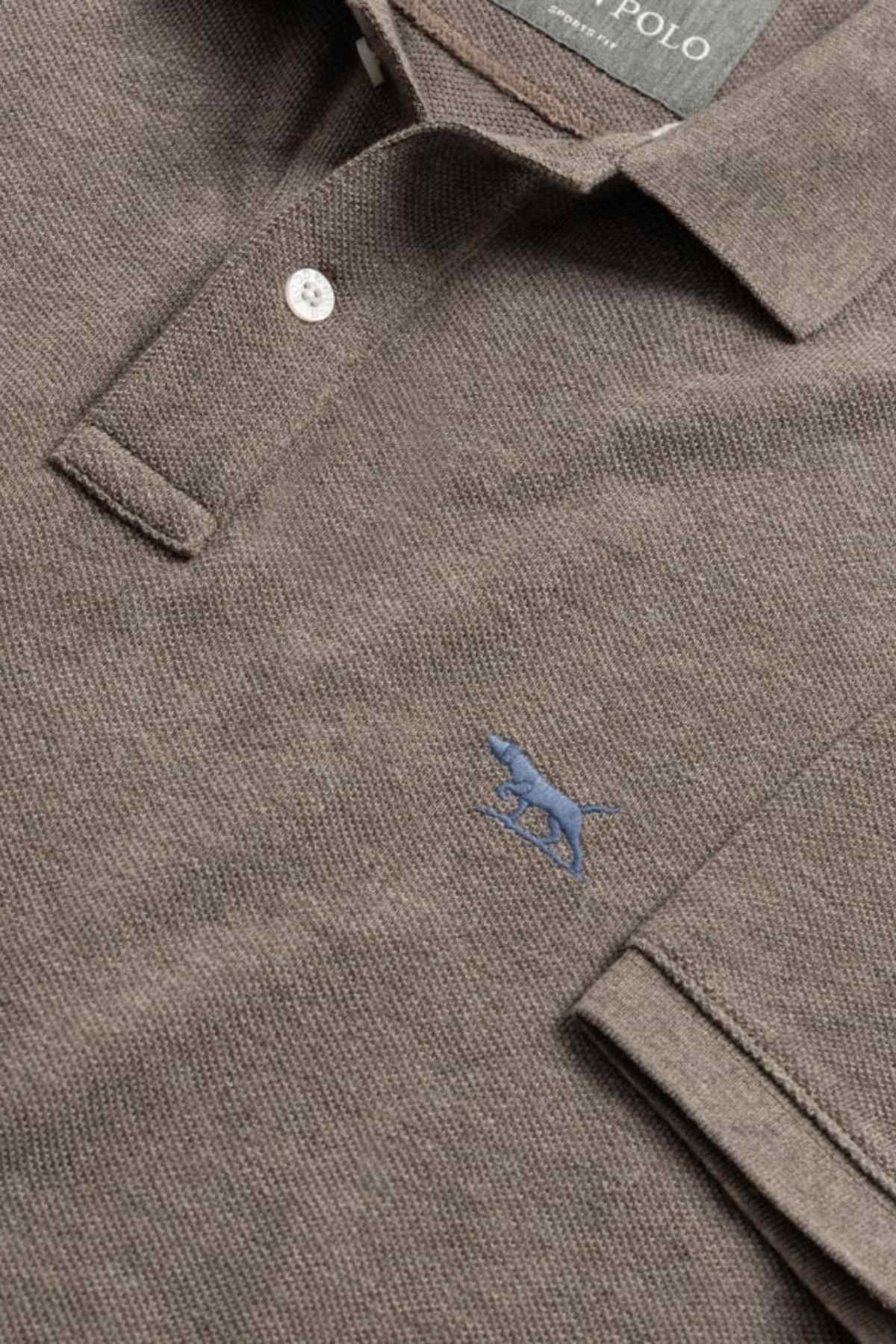 A close-up of the Rodd & Gunn The Gunn Polo in brown, made from soft Australian cotton, features a collar, a small blue embroidered dog logo on the chest, and a visible button at the neckline.