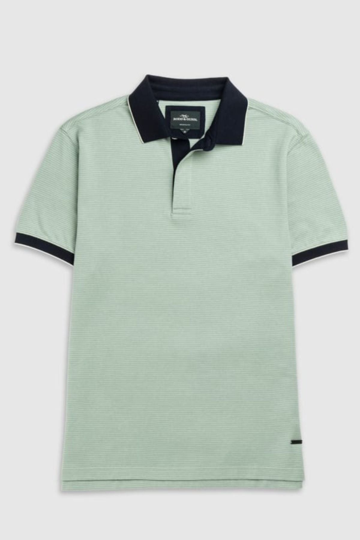 The Rodd & Gunn Wilson Bay Sports Fit Polo is a light green shirt featuring a dark collar and cuffs. Made from breathable birdseye knit, it has a subtle striped texture and a discreet logo near the hem, delivering comfort and style.