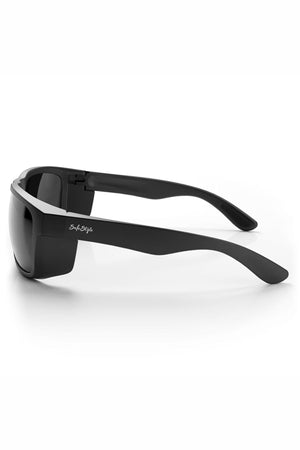 The SafeStyle Rapids Matte Black Frame Polarised Lens sunglasses feature thick arms, dark polarised lenses for UV protection, and a subtle white brand name on the arm. Shown from a side angle on a white background.