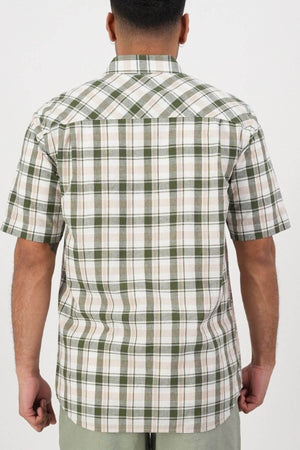A person is shown from behind wearing the Swanndri Coleridge Short Sleeve Shirt, featuring green, white, and beige plaid stripes in a cotton linen blend. The untucked shirt is paired with light pants against a plain white background.