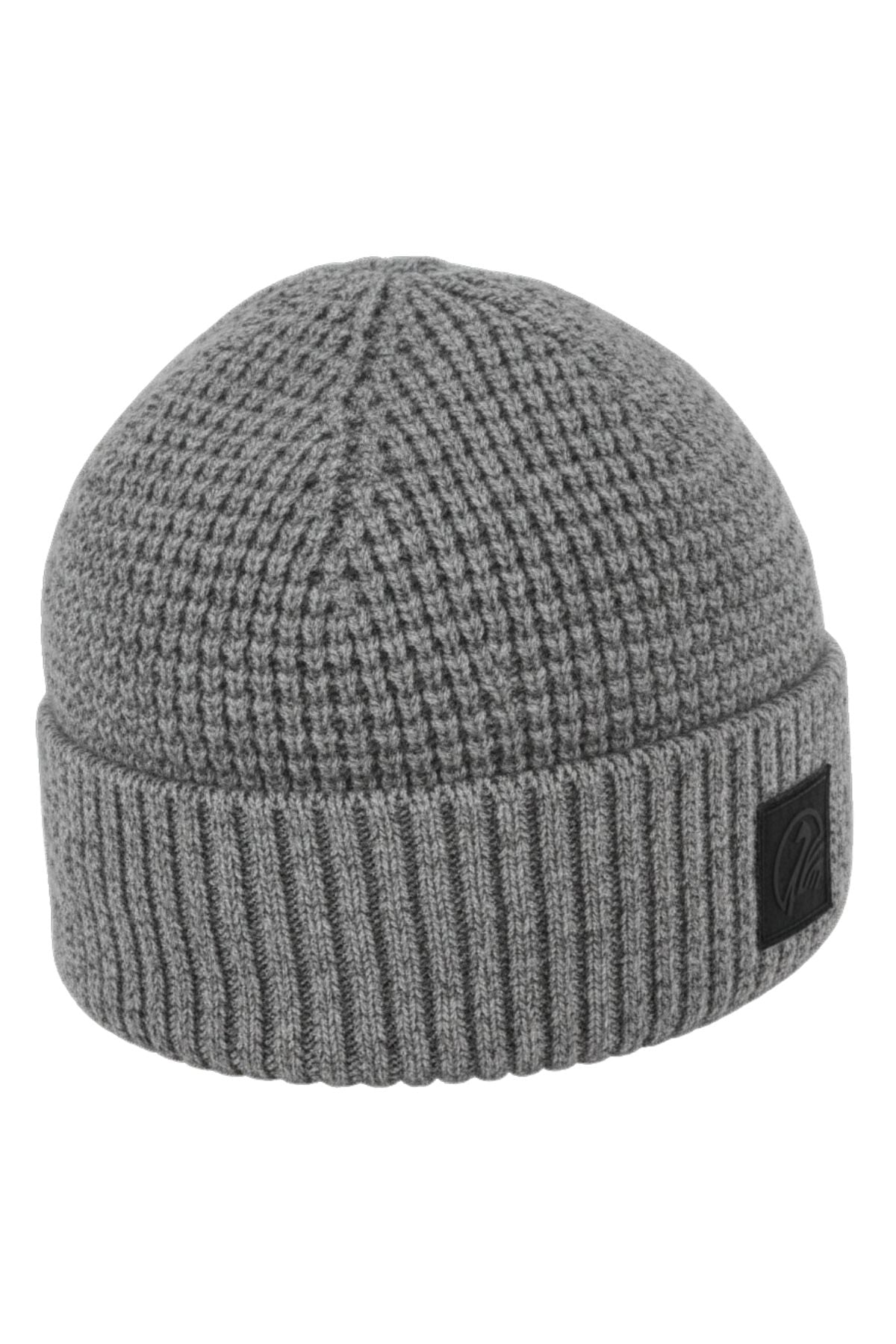 The Swanndri Newton Beanie is a gray lambswool beanie featuring a ribbed fold-over cuff and a small black patch on the front.