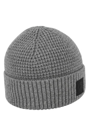 The Swanndri Newton Beanie is a gray lambswool beanie featuring a ribbed fold-over cuff and a small black patch on the front.
