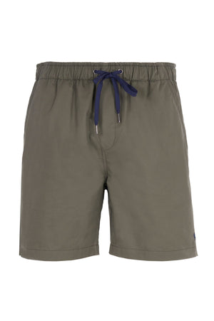 Olive green Thomas Cook Darcy Shorts, made from 100% cotton, with an elasticated waistband, navy blue drawstring, and practical side pockets, shown on a white background.
