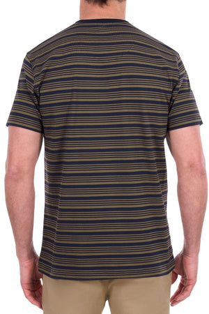 A person is shown from the back against a white background, wearing the Thomas Cook Oliver Teeโa short-sleeve navy and olive striped shirt made from soft cotton jerseyโpaired with beige pants.
