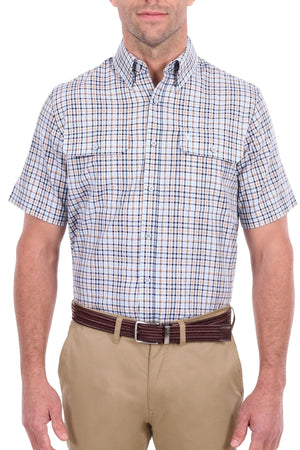 A man wearing the Thomas Cook Ted Short Sleeve Shirt—a blue and brown cotton check Western style with two chest pockets—tucked into khaki pants with a dark brown belt, standing against a white background.