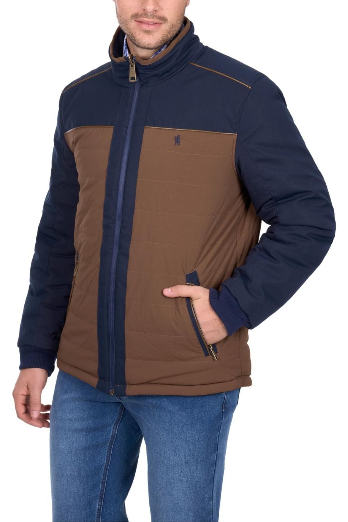 A man wears the Thomas Cook Toby Reversible Jacket in brown and navy blue, featuring a high collar, side pockets, and a small chest logo, paired with blue jeans. His face is partially visible.