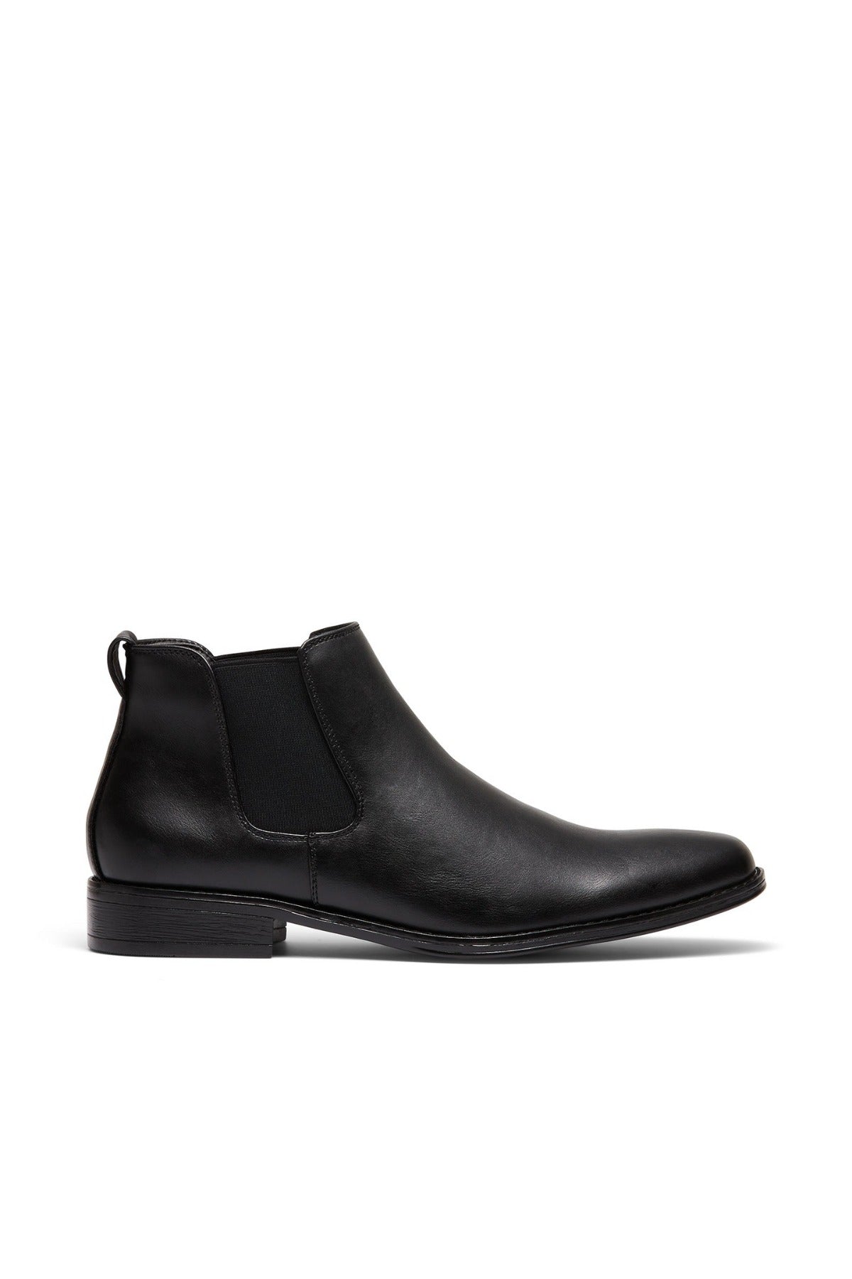 The UNcut Canterbury Boot is a durable black leather Chelsea boot with elastic side gussets, a low heel, and a back pull tab, shown in profile on a white background.