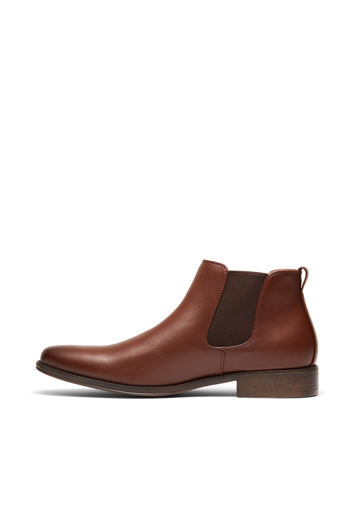 The UNcut Canterbury Boot is a brown leather Chelsea style with a low heel, elastic side gussets, and a pull tab at the back. Displayed against a plain white background, it elegantly highlights its sleek side profile.