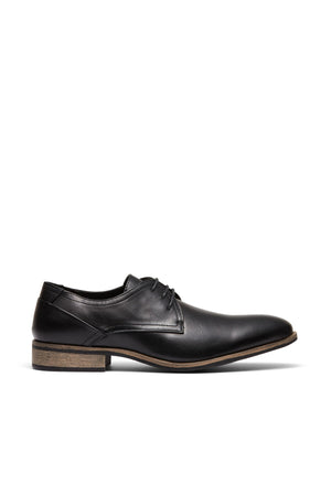 The UNcut Rhine Shoe features a black non-leather upper, low wooden heel, and black laces, displayed in a side profile on a white background—ideal for formal occasions.
