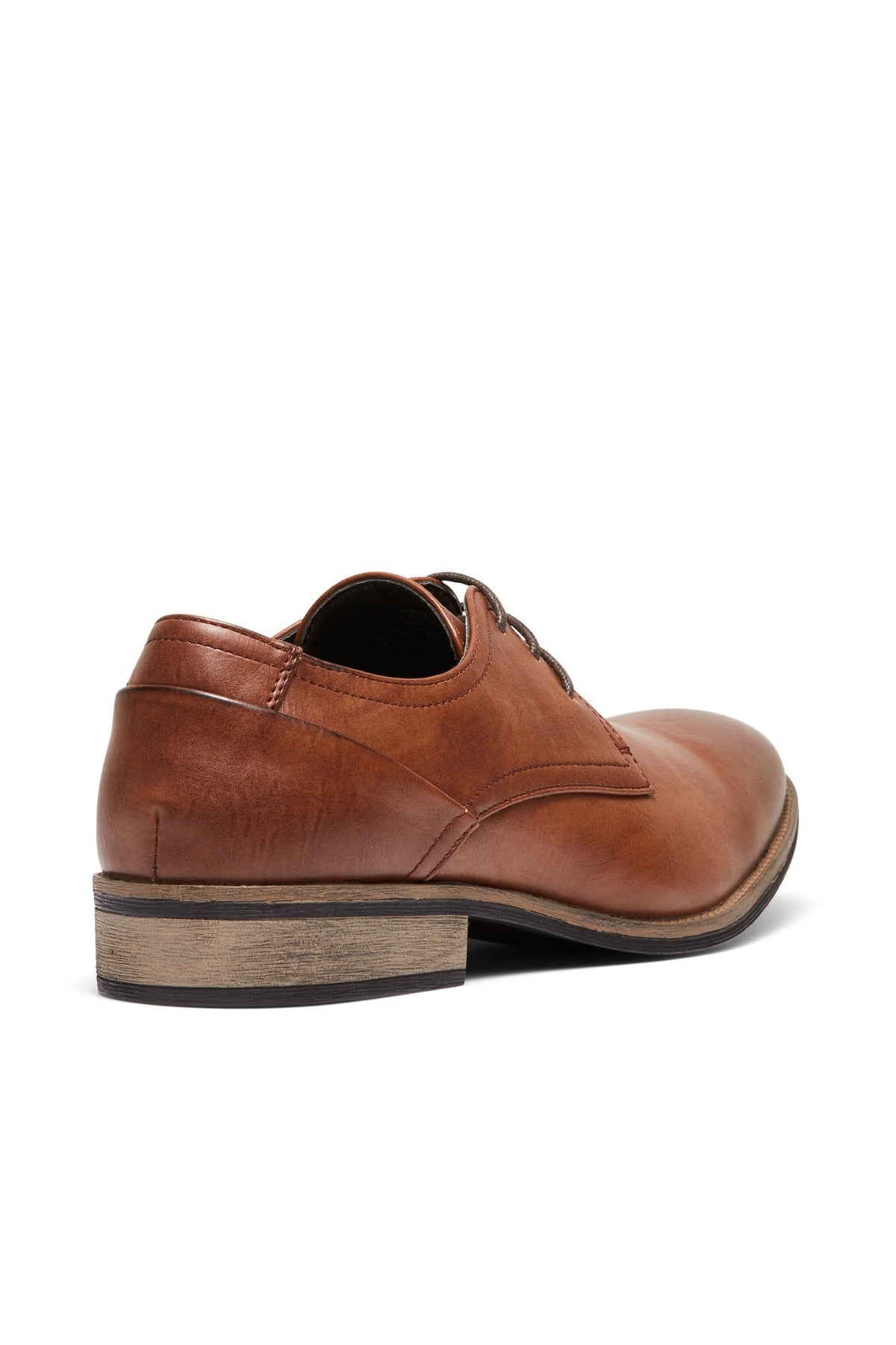 The UNcut Rhine Shoe is a brown dress shoe with a low stacked wooden heel, lace-up design, and stitching details. Seen from the back and side, it's an ideal choice for formal occasions.