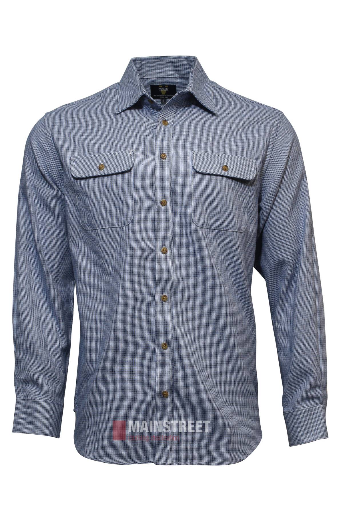 The Vonnella Double Pocket Shirt is a light blue, long sleeve shirt with a subtle checkered pattern, buttoned chest pockets, and brown buttons down the front.