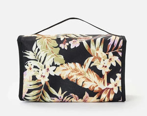 The Rip Curl Rolled Beauty Sunday Swell Toiletry Bag features a striking floral pattern with large orange, green, and white leaves and flowers. It includes a top handle and waterproof pockets, combining style and practicality effortlessly.