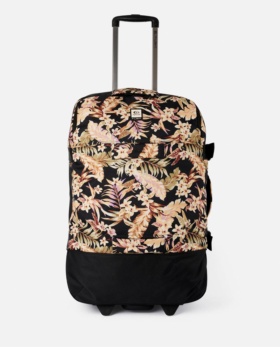 The Rip Curl F-Light Global 110L Sunday Travel Bag is a stylish travel bag featuring a black, beige, and pink floral pattern with wheels, lockable zips, and a telescopic handle for effortless transport.