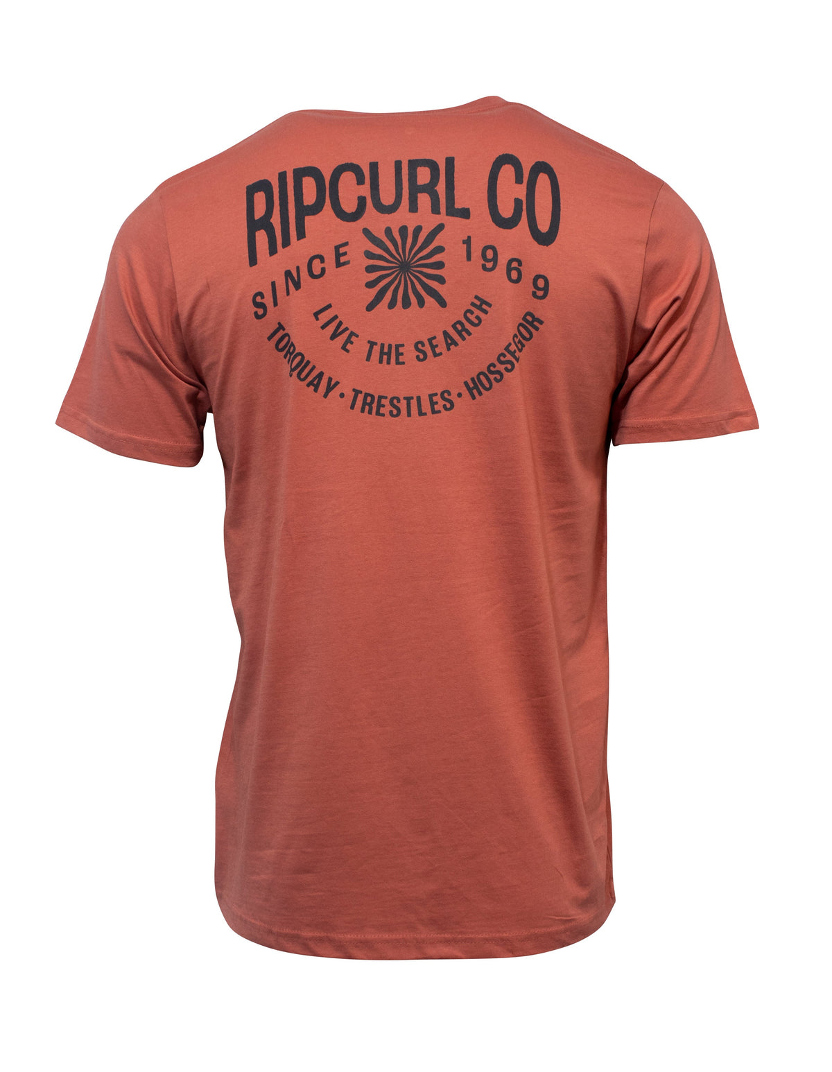 The Rip Curl Cosmic Burst Tee is rust-colored, 100% cotton, with short sleeves, bold black back text, a sunburst graphic, and features iconic locations: Torquay, Trestles, Hossegor—perfect for casual everyday wear.