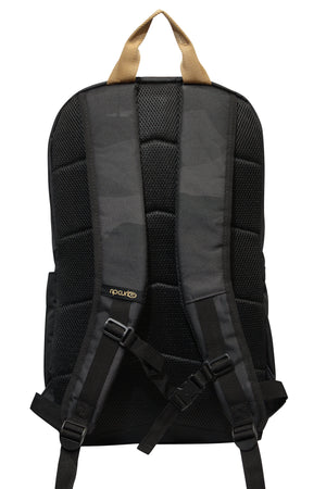 The Rip Curl Overtime 30L Backpack, in black and made from recycled polyester, features beige handles, padded shoulder straps, adjustable chest strap for stability, and a textured mesh design. It stylishly accommodates a 15" laptop with ease.