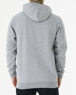 Facing away, someone is wearing the Rip Curl Corp Icon Zip Thru, a comfortable light gray hoodie with the hood pulled up and long sleeves, paired with dark pants, set against a plain white background.