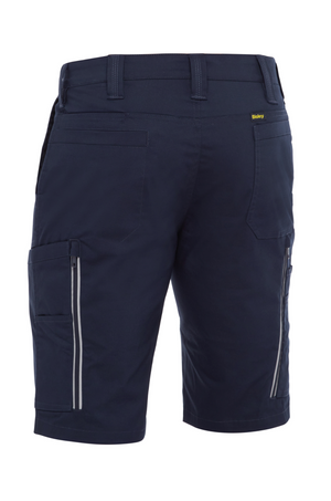 Rear view of the Bisley X Airflow Stretch Ripstop Vented Cargo Short in navy blue, made from stretch ripstop fabric. Features multiple pockets including zippered sides, belt loops, reflective zip leg vents, and a small yellow tag near the waistband.