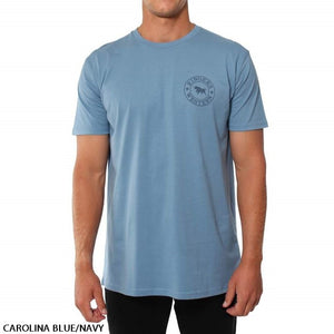 A person is wearing a Carolina Blue/Navy Ringers Western Signature Bull Original Fit T-Shirt, featuring a small circular penguin logo on the left side of the chest. The individual is standing against a plain white background, paired with black pants.