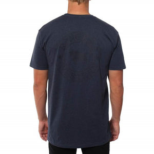 A person with short hair is wearing a comfortable navy blue Ringers Western Signature Bull Original Fit T-Shirt made of 100% cotton, featuring a subtle circular graphic on the back. The person is standing with their back facing the camera against a plain white background.