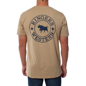 A person is wearing the Ringers Western Signature Bull Original Fit T-Shirt in beige, crafted from 100% cotton. The comfortable T-shirt features a large circular logo in navy blue on the back, showcasing a bull in the center, surrounded by the text "Ringers Western" and stars. The person is facing away, highlighting the detailed design on the back of the T-shirt.