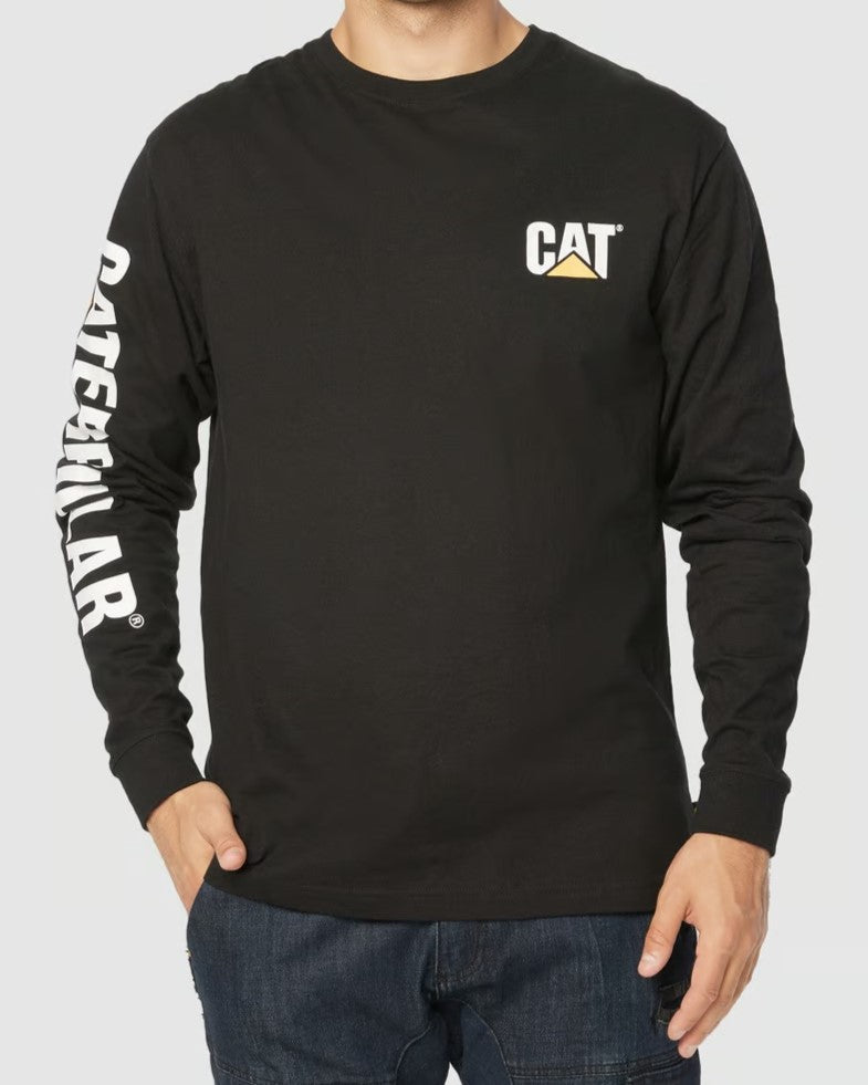 A person is wearing the CAT Trademark Banner Long Sleeve Tee, 100% cotton and black, featuring the "CAT" logo on the chest and "Caterpillar" on the sleeve. They stand against a light background with dark jeans for a sleek look.