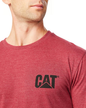 Someone is wearing a comfortable red CAT Trademark Banner Long Sleeve Tee, featuring a black "CAT" logo on the chest against a plain white background.