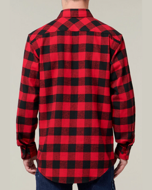 A person is seen from the back wearing a Hard Yakka Check Flannelette Shirt in red and black checkered flannel, with long sleeves and buttoned cuffs. Paired with blue jeans, it stands out against a plain light gray background with UPF 50+ protection.