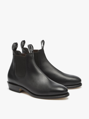 The RM Williams Adelaide Kangaroo Boot is a black boot made from premium kangaroo leather, featuring elastic side panels, pull tabs with white text, low stacked heels, and rounded toes—ideal for smart-casual style.
