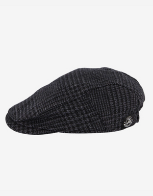 The Swanndri Bristol Flat Cap is crafted from soft wool, featuring a dark plaid design with a subtle checkered pattern and a small logo button on one side, set against a plain white background.