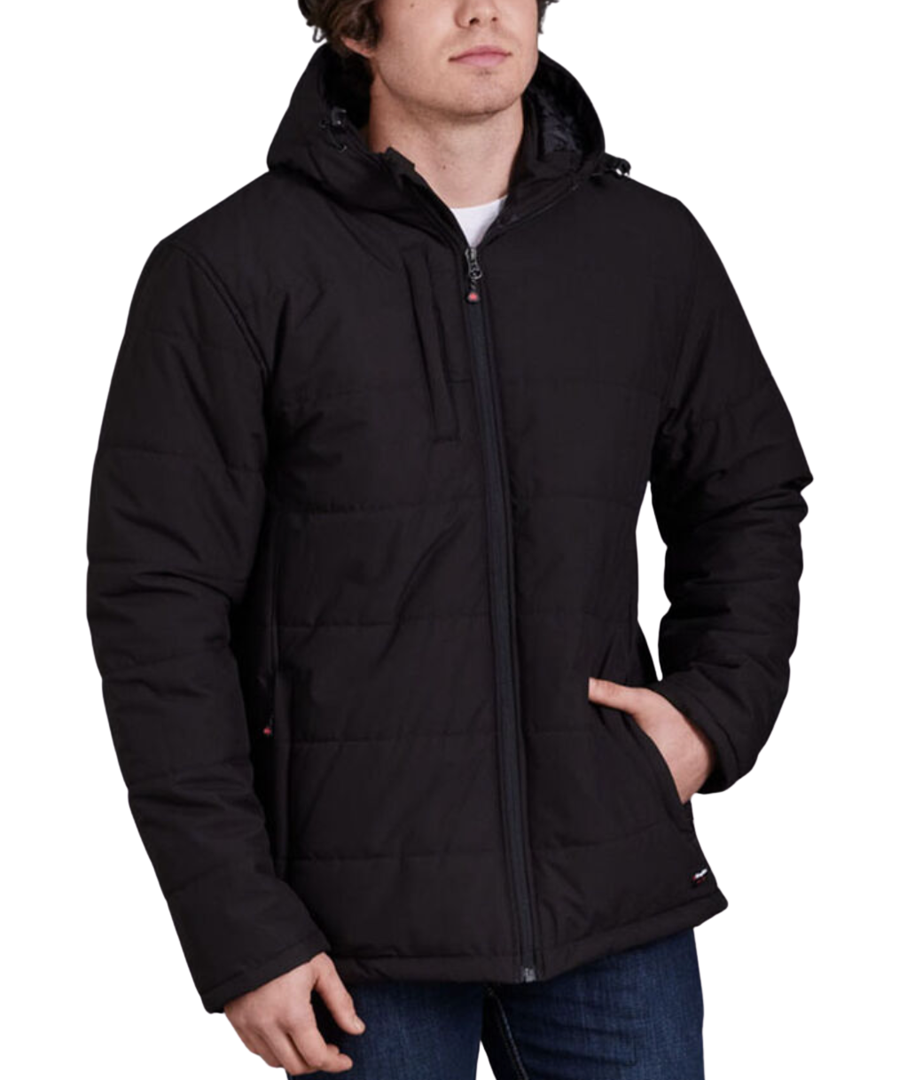 Wearing a King Gee Puffer Jacket in black with a hood and water-repellent finish, someone stands stylishly with one hand in a side pocket. The quilted pattern and front zipper add flair, while practicality is ensured by two side pockets. It pairs effortlessly with blue jeans.
