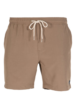 The UNIT Boardwalk Elastic Waist Short for men features tan 4-way stretch fabric, an elastic waistband with a white drawstring, side pockets, and a small black UNIT logo near the left hem, shown against a white background.