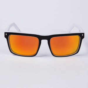 Introducing the UNIT Primer Polarised Eyewear: a pair of stylish sunglasses featuring a lightweight white frame. The polarised lenses are rectangular and boast a vivid gradient, transitioning from orange to yellow. Offering UV protection, these modern and sleek sunglasses are set against a plain white background.