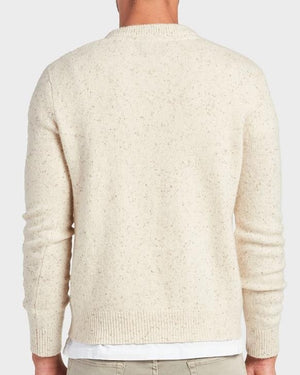 A person is shown from the back wearing the Academy Brand Shoreditch Crew Knit, a cream-colored, speckled lambswool jumper with ribbed cuffs and hem, styled over a white shirt and light-colored pants.