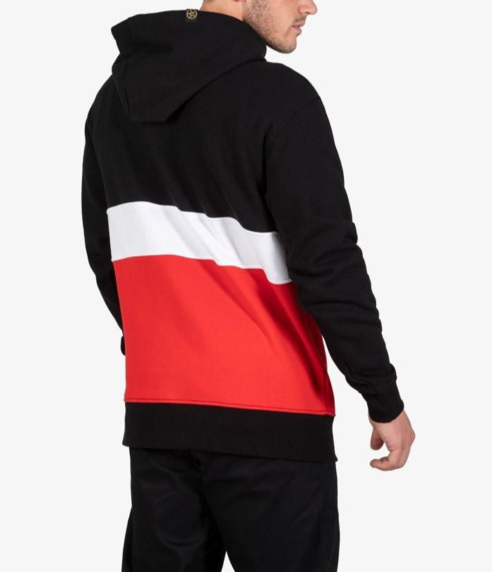 A man wears the UNIT Express Hoodie Fleece featuring black, white, and red color blocks. Viewed from the back with hood up, he looks slightly to the side against a plain background.