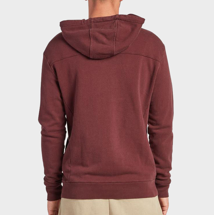 A person is shown from the back wearing a maroon Academy Brand Boston Hoodie and beige pants, standing against a plain light gray background.