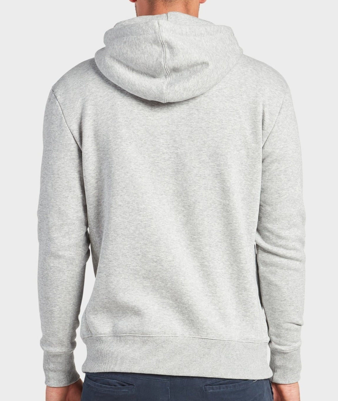 A person is seen from the back in an Academy Brand College Hoodie in light gray and dark pants, hood down, creating a relaxed, casual look against a plain white background.