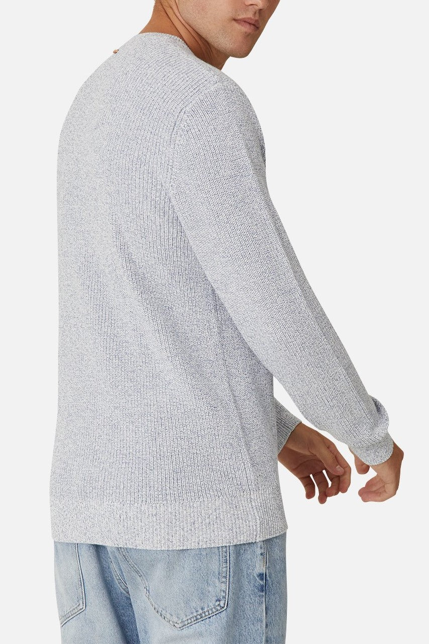 A man is shown from the back, turning slightly left, wearing the Industrie The Kingston Knit in light gray (100% cotton, waffle knit) with light blue jeans against a plain white background.