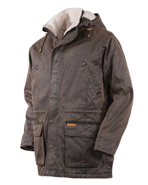 The Outback Nolan Jacket is a brown, rugged winter jacket featuring a hood and sherpa lining. This water-resistant jacket comes with a front zipper covered by a button-flap, two large front pockets with flap closures, and two angled chest pockets. It also has adjustable drawstrings on the hood and boasts a sturdy, worn appearance.