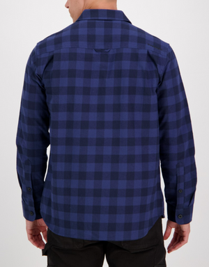 A person, seen from behind, wears the Swanndri Taranaki Tailor Shirt—a stylish long-sleeved blue and black checkered 100% cotton shirt with buttoned cuffs—untucked over dark pants, against a plain light background.