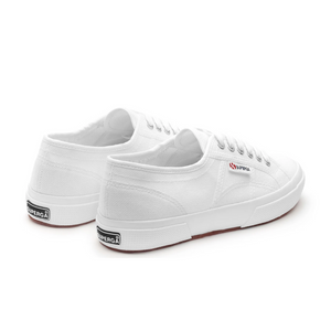 Superga Cotu Classic Sneakers have white canvas uppers, matching laces, and rubber soles. The "Superga" brand name is prominently displayed on the side and heel against a white background.