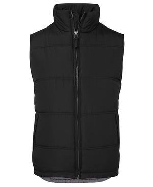 The JBs Adventure Vest is a sleeveless black puffer with extra thick fill, front zipper, high collar, and two side pockets—displayed on white background—making it a cozy, casual choice for urban style.