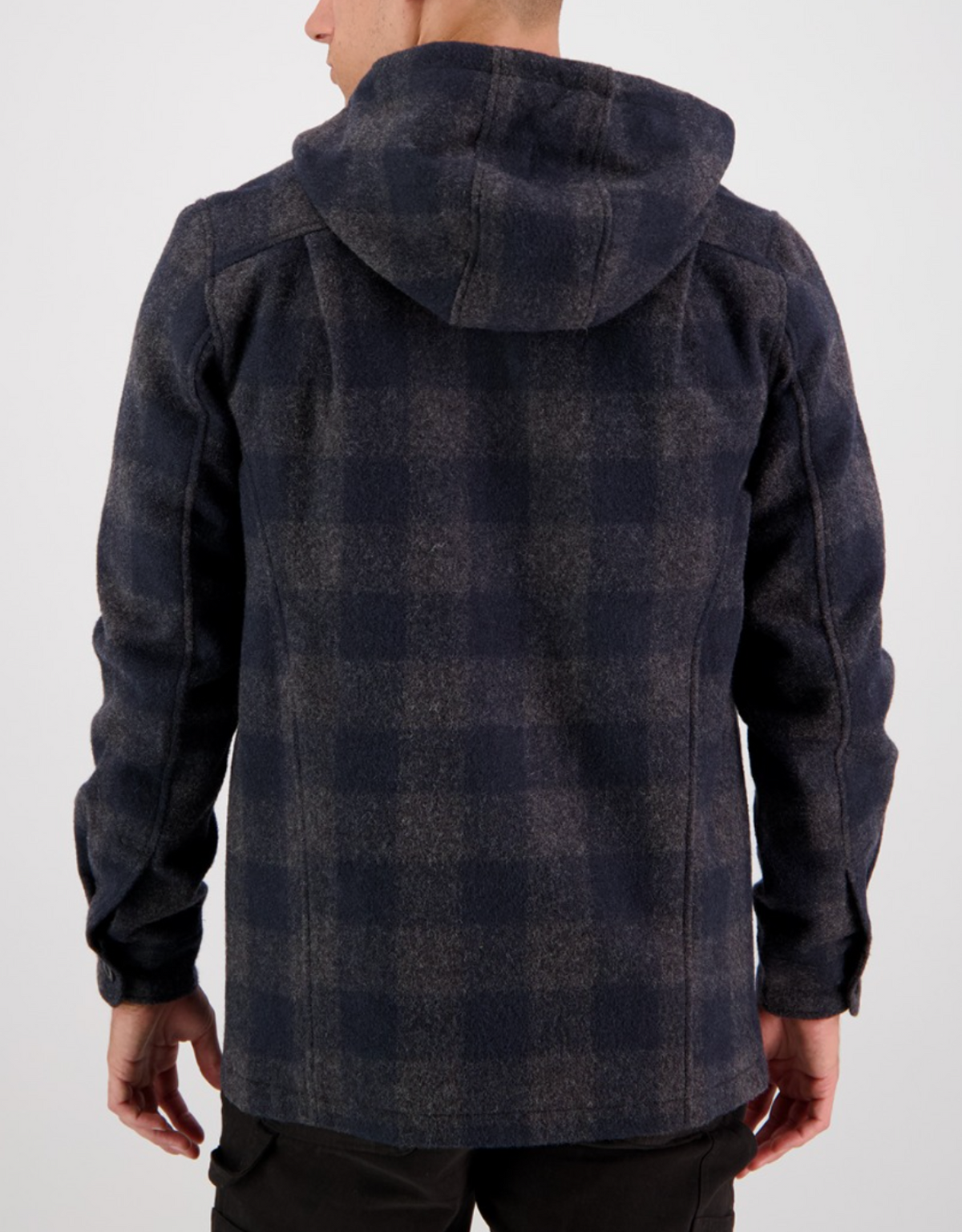 A person is shown from the back wearing the Swanndri Hudson Hoody, a dark plaid jacket made from New Zealand wool in a dark blue and gray checkered pattern, paired with black pants against a plain white background.