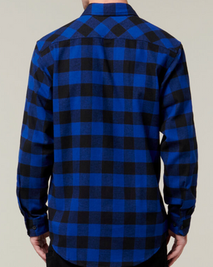 A person is shown from the back wearing a hard-wearing Hard Yakka Check Flannelette Shirt with a blue and black checkered pattern and long sleeves. The person has their arms down at their sides, and the background is a plain light color.