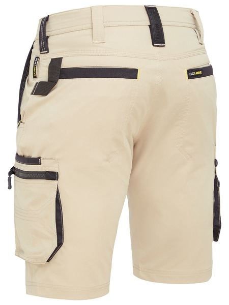The Bisley Flex & Move 4 Way Stretch Zip Cargo Shorts are in khaki with black accents, featuring multifunctional cargo, side, and back pockets. With belt loops and a small brand label present, the durable 4-way stretch fabric makes them ideal for outdoor activities.