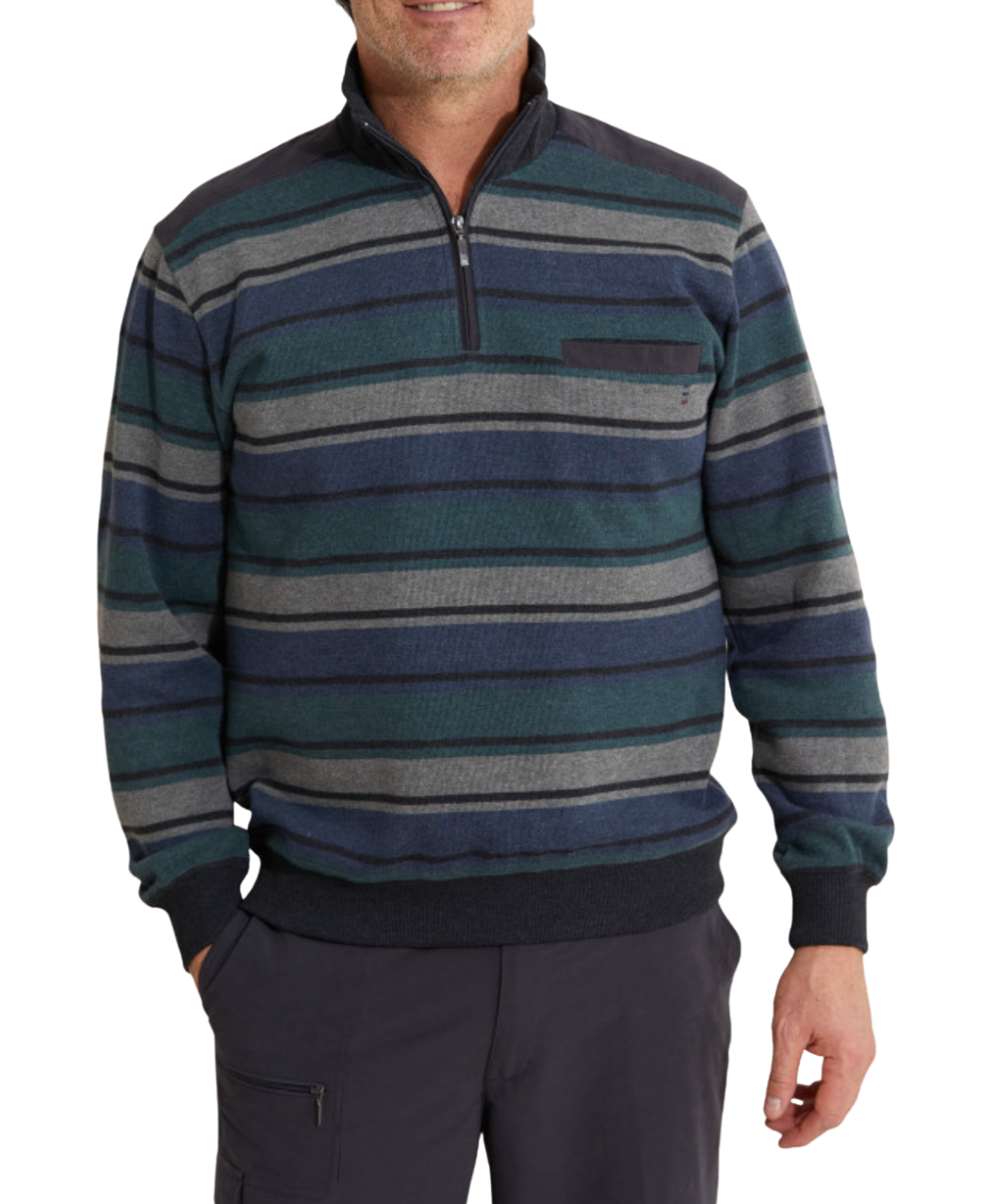 A person is wearing the Breakaway Fox French Rib Half Zip sweater with dark blue, green, gray, and black stripes. This stylish pullover features a half-zip and a chest pocket. Complemented by dark pants, one hand rests casually in their pocket while their head remains out of view.