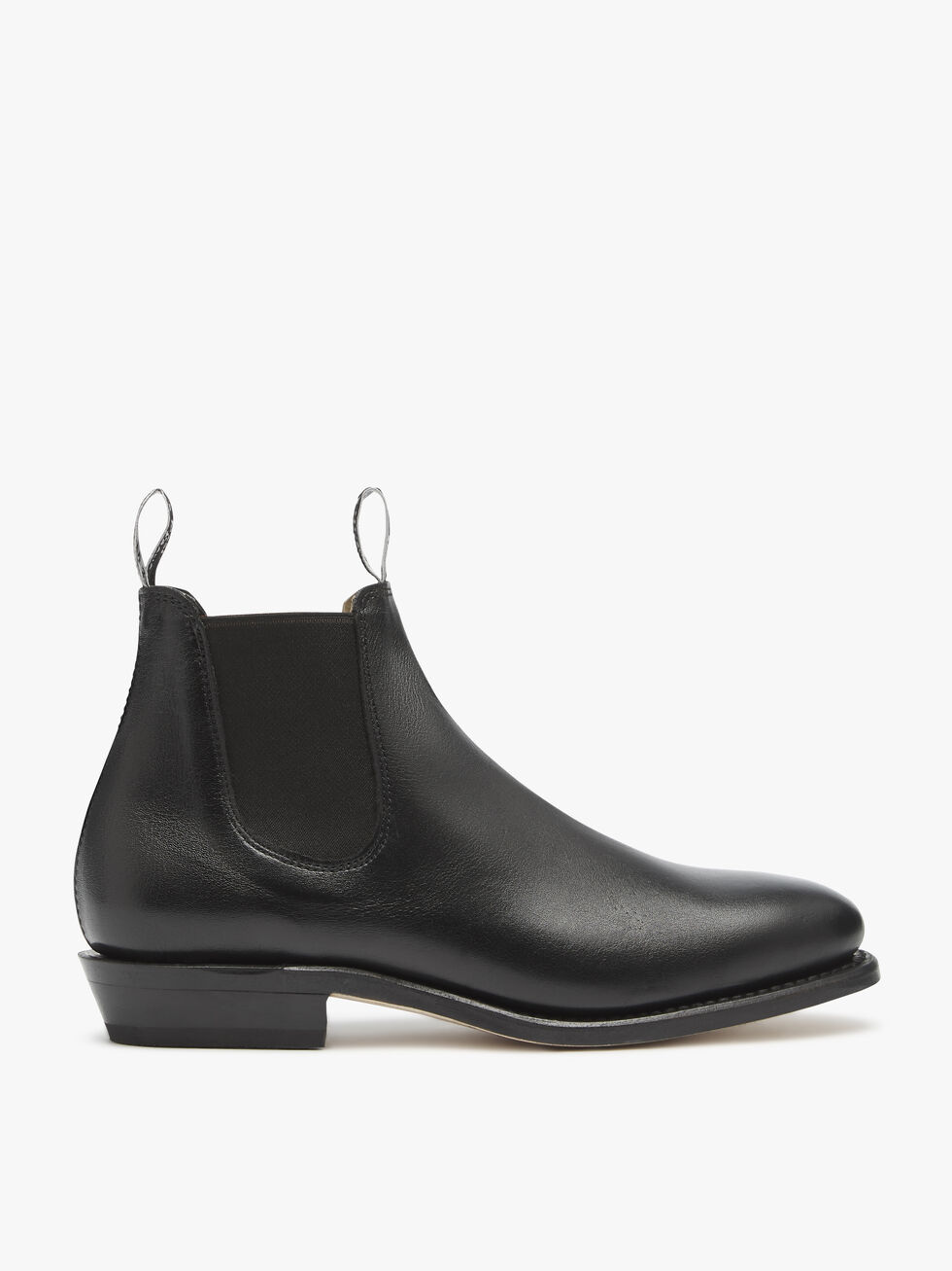 The RM Williams Adelaide Kangaroo Boot features black leather, elastic side panels, front and back pull tabs, a rounded toe, and low heel for smart-casual style. Displayed in side profile against a plain white background.