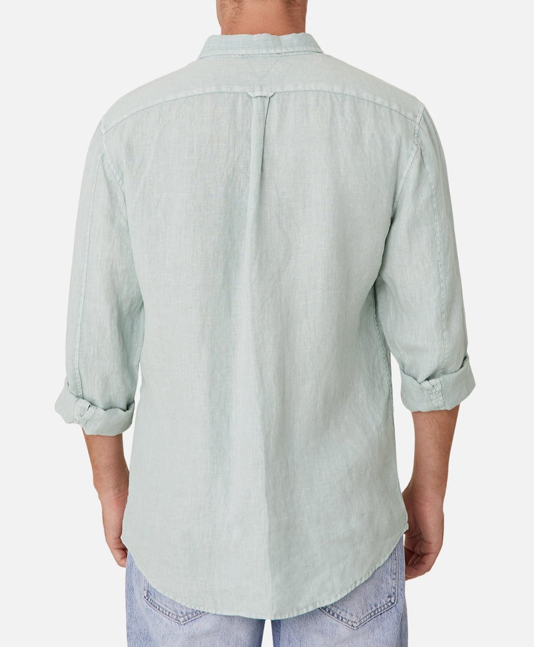 A person is wearing the Industrie The Tennyson Linen Shirt in light green, made of 100% linen. The long sleeves are rolled up to show the marle texture, paired with light blue jeans against a plain white background. Viewed from the back.