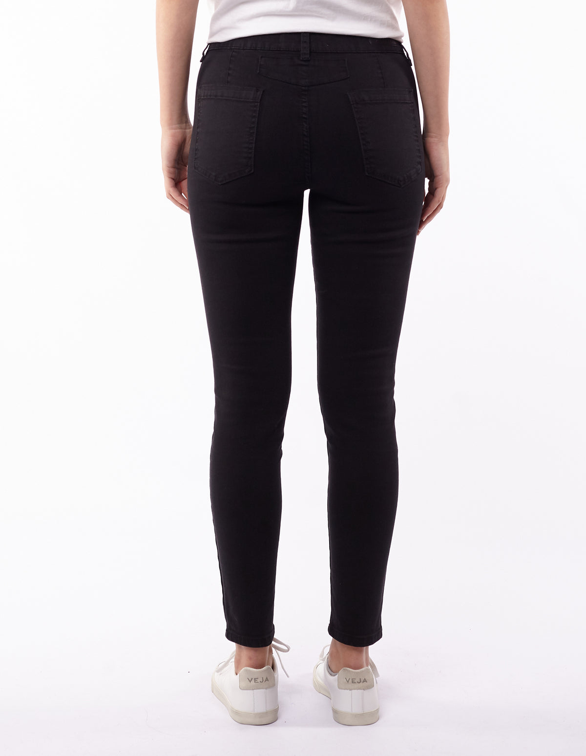 Back view of a person wearing Foxwood City Jean in black and white sneakers, standing against a plain white background.